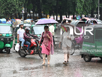 A person with an umbrella makes their way along a street during heavy rainfall in Dhaka, Bangladesh, on September 15, 2024. (