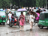 A person with an umbrella makes their way along a street during heavy rainfall in Dhaka, Bangladesh, on September 15, 2024. (