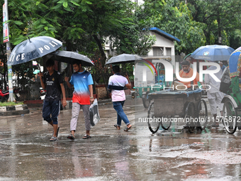 A person with an umbrella makes their way along a street during heavy rainfall in Dhaka, Bangladesh, on September 15, 2024. (