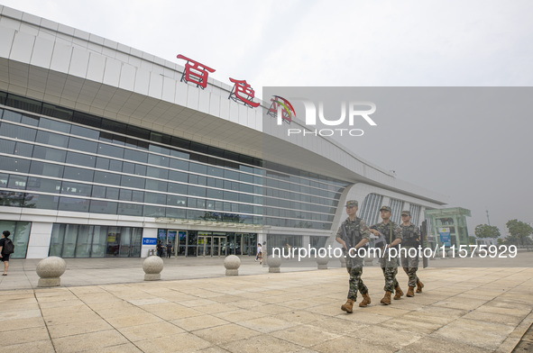 Armed police officers patrol a station during the Mid-Autumn Festival in Baise, China, on September 15, 2024. 