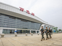 Armed police officers patrol a station during the Mid-Autumn Festival in Baise, China, on September 15, 2024. (