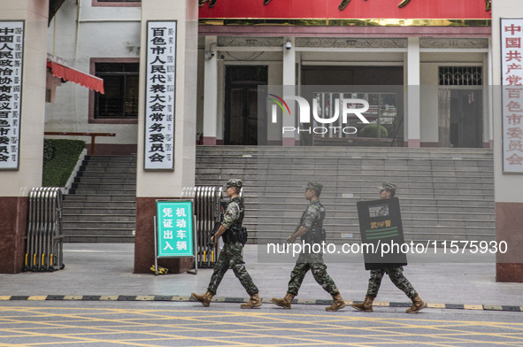 Armed police officers patrol during the Mid-Autumn Festival in Baise, China, on September 15, 2024. 