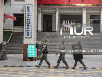 Armed police officers patrol during the Mid-Autumn Festival in Baise, China, on September 15, 2024. (