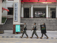 Armed police officers patrol during the Mid-Autumn Festival in Baise, China, on September 15, 2024. (