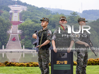 Armed police officers are on duty at a scenic spot during the Mid-Autumn Festival in Baise, China, on September 15, 2024. (