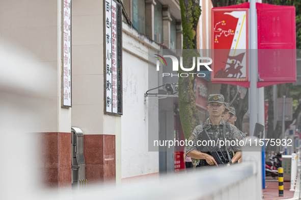 Armed police officers patrol during the Mid-Autumn Festival in Baise, China, on September 15, 2024. 