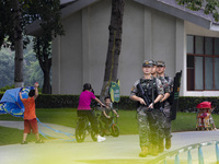 Armed police officers patrol a scenic spot during the Mid-Autumn Festival in Baise, China, on September 15, 2024. (