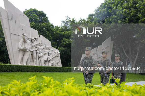 Armed police officers patrol a scenic spot during the Mid-Autumn Festival in Baise, China, on September 15, 2024. 