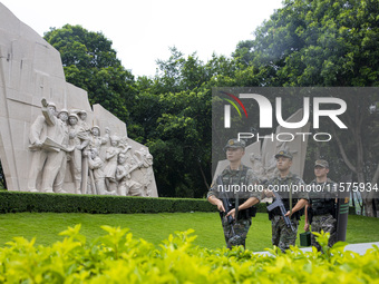 Armed police officers patrol a scenic spot during the Mid-Autumn Festival in Baise, China, on September 15, 2024. (