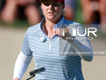 GAINESVILLE, VIRGINIA - SEPTEMBER 14: Ally Ewing of the United States tosses up her ball at the 14th green during Day Two of the Solheim Cup...