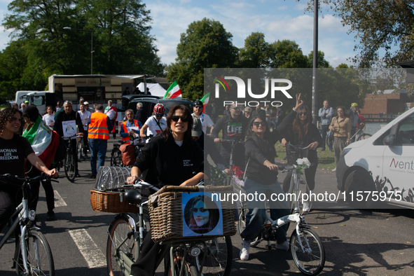 A hundred people take part in a bike demonstration to mark the second anniversary of Mahsa Amini's death for the Woman, Life, and Freedom mo...