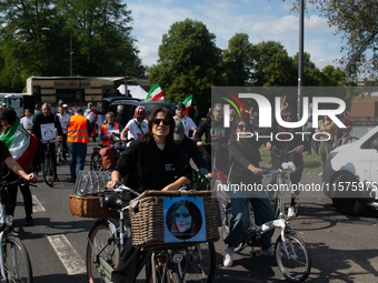 A hundred people take part in a bike demonstration to mark the second anniversary of Mahsa Amini's death for the Woman, Life, and Freedom mo...