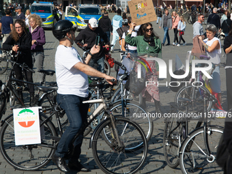 A hundred people take part in a bike demonstration to mark the second anniversary of Mahsa Amini's death for the Woman, Life, and Freedom mo...