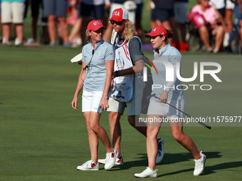 GAINESVILLE, VIRGINIA - SEPTEMBER 14: Ally Ewing of the United States walks with Captain Stacy Lewis of the United States to the 14th green...