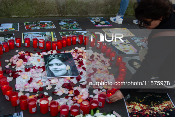 A memorial site with candle lights is set as a hundred people take part in a bike demonstration to mark the second anniversary of Mahsa Amin...