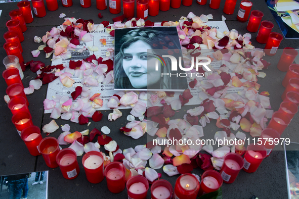 A memorial site with candle lights is set as a hundred people take part in a bike demonstration to mark the second anniversary of Mahsa Amin...