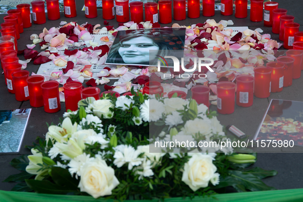 A memorial site with candle lights is set as a hundred people take part in a bike demonstration to mark the second anniversary of Mahsa Amin...