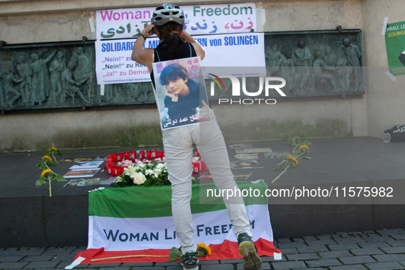 A memorial site with candle lights is set as a hundred people take part in a bike demonstration to mark the second anniversary of Mahsa Amin...