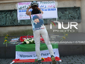 A memorial site with candle lights is set as a hundred people take part in a bike demonstration to mark the second anniversary of Mahsa Amin...