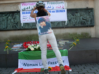 A memorial site with candle lights is set as a hundred people take part in a bike demonstration to mark the second anniversary of Mahsa Amin...