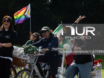 A hundred people take part in a bike demonstration to mark the second anniversary of Mahsa Amini's death for the Woman, Life, and Freedom mo...