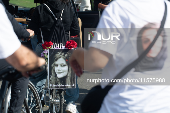 A hundred people take part in a bike demonstration to mark the second anniversary of Mahsa Amini's death for the Woman, Life, and Freedom mo...