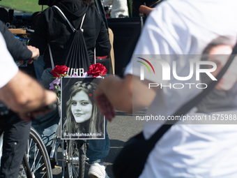 A hundred people take part in a bike demonstration to mark the second anniversary of Mahsa Amini's death for the Woman, Life, and Freedom mo...