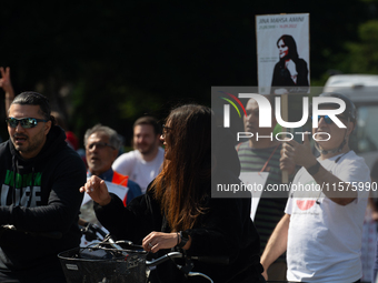 A hundred people take part in a bike demonstration to mark the second anniversary of Mahsa Amini's death for the Woman, Life, and Freedom mo...