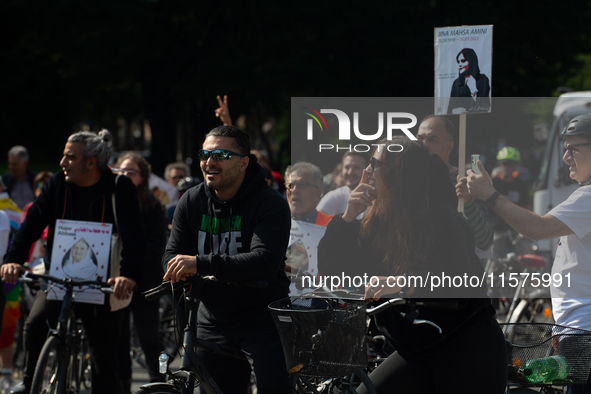 A hundred people take part in a bike demonstration to mark the second anniversary of Mahsa Amini's death for the Woman, Life, and Freedom mo...