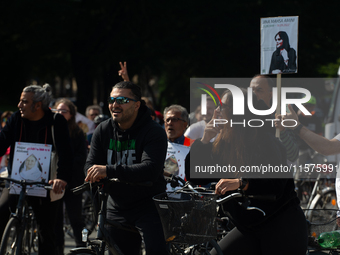 A hundred people take part in a bike demonstration to mark the second anniversary of Mahsa Amini's death for the Woman, Life, and Freedom mo...