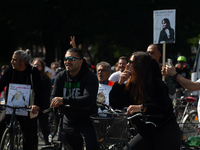 A hundred people take part in a bike demonstration to mark the second anniversary of Mahsa Amini's death for the Woman, Life, and Freedom mo...