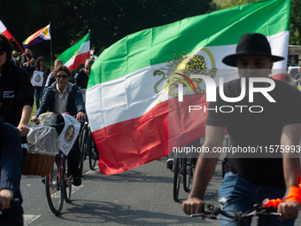 A hundred people take part in a bike demonstration to mark the second anniversary of Mahsa Amini's death for the Woman, Life, and Freedom mo...