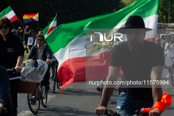 A hundred people take part in a bike demonstration to mark the second anniversary of Mahsa Amini's death for the Woman, Life, and Freedom mo...