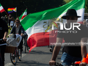 A hundred people take part in a bike demonstration to mark the second anniversary of Mahsa Amini's death for the Woman, Life, and Freedom mo...