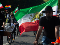 A hundred people take part in a bike demonstration to mark the second anniversary of Mahsa Amini's death for the Woman, Life, and Freedom mo...