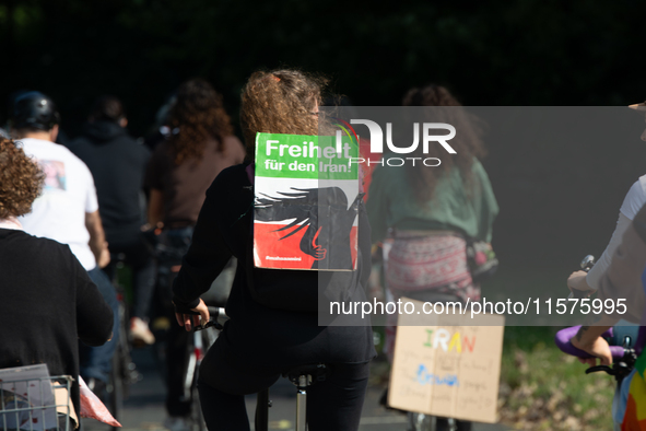 A hundred people take part in a bike demonstration to mark the second anniversary of Mahsa Amini's death for the Woman, Life, and Freedom mo...