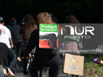 A hundred people take part in a bike demonstration to mark the second anniversary of Mahsa Amini's death for the Woman, Life, and Freedom mo...