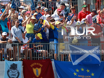 GAINESVILLE, VIRGINIA - SEPTEMBER 14:  Fans in Team Europe spirit wear cheer from the gallery at the 1st tee during Day Two of the Solheim C...