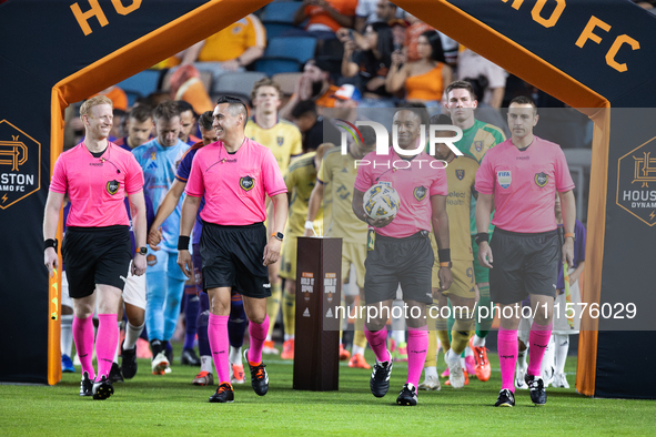 The referees walk onto the pitch ahead of a match against Real Salt Lake at Shell Energy Stadium in Houston, Texas, on September 14, 2024. 