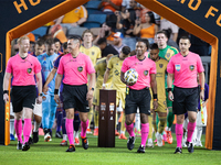 The referees walk onto the pitch ahead of a match against Real Salt Lake at Shell Energy Stadium in Houston, Texas, on September 14, 2024. (