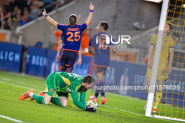 Moments after a goal, Houston Dynamo players Griffin Dorsey and Ezequiel Ponce celebrate behind Real Salt Lake goalkeeper Gavin Beavers (35)...