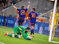 Moments after a goal, Houston Dynamo players Griffin Dorsey and Ezequiel Ponce celebrate behind Real Salt Lake goalkeeper Gavin Beavers (35)...