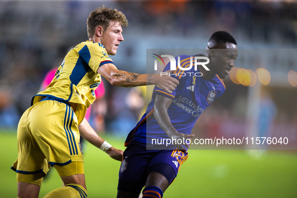 Real Salt Lake midfielder Bode Hidalgo (19) grabs Houston Dynamo forward Ibrahim Aliyu's arm during a match between Houston Dynamo and Real...