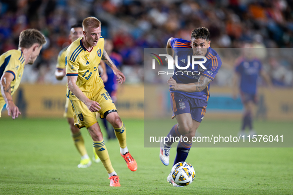 Real Salt Lake defender Justen Glad (15) and Houston Dynamo forward Ezequiel Ponce (10) chase the ball during a match between Houston Dynamo...