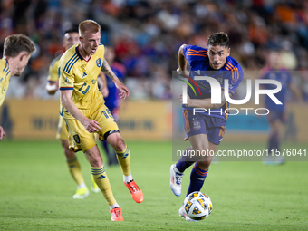 Real Salt Lake defender Justen Glad (15) and Houston Dynamo forward Ezequiel Ponce (10) chase the ball during a match between Houston Dynamo...