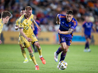 Real Salt Lake defender Justen Glad (15) and Houston Dynamo forward Ezequiel Ponce (10) chase the ball during a match between Houston Dynamo...