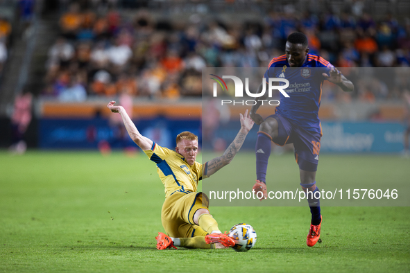 Real Salt Lake defender Justen Glad (15) steals the ball from Houston Dynamo forward Ibrahim Aliyu (18) during a match between Houston Dynam...