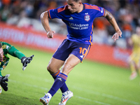 Real Salt Lake goalkeeper Gavin Beavers (35) attempts to block a shot from Houston Dynamo forward Ezequiel Ponce (10) but misses the ball, r...