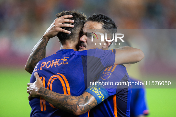 Houston Dynamo forward Ezequiel Ponce (10) and midfielder Jose De Lima Junior ''Artur'' (6) hug after scoring a goal during a match between...