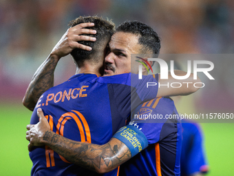 Houston Dynamo forward Ezequiel Ponce (10) and midfielder Jose De Lima Junior ''Artur'' (6) hug after scoring a goal during a match between...